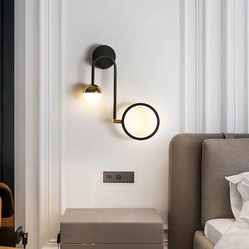 Close-up of wrought iron arm and gold accent on wall sconce | Casa Norex
