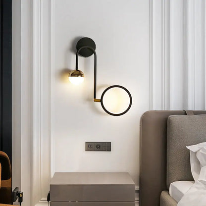 Close-up of wrought iron arm and gold accent on wall sconce | Casa Norex