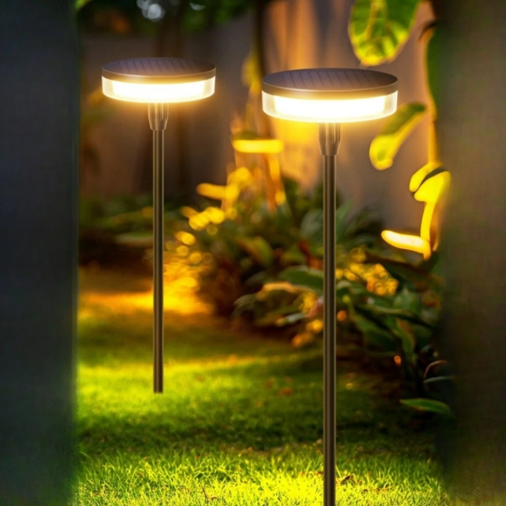Solar swaying garden stake pathway light in a flower bed