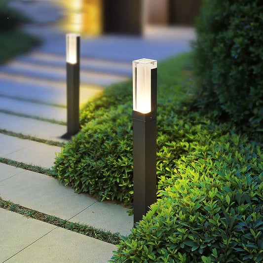Aluminum LED lawn lamp lighting up a backyard at dusk
