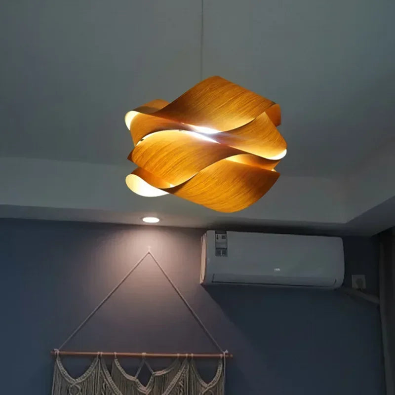 Kaya wood pendant light glowing amber over a table — Casa Norex