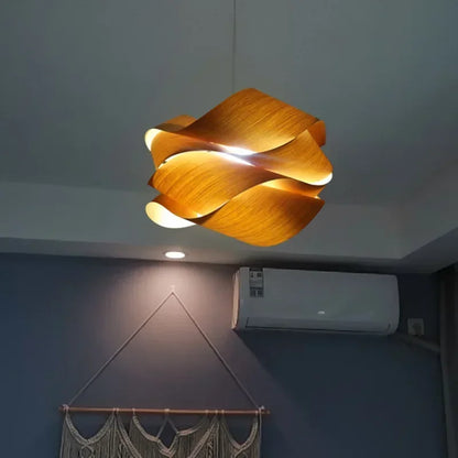 Kaya wood pendant light glowing amber over a table — Casa Norex