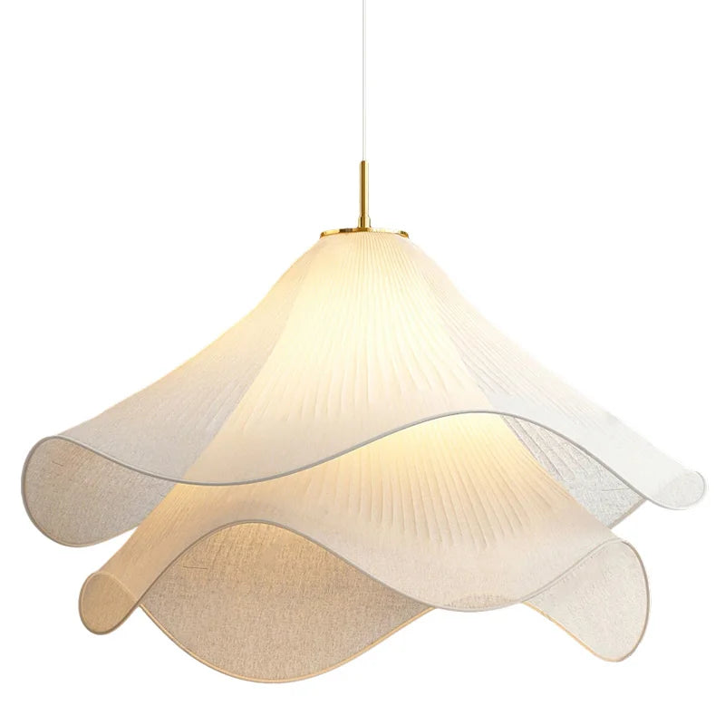 Fabric flower pendant light lit — pleated petal shade with gold canopy | Casa Norex