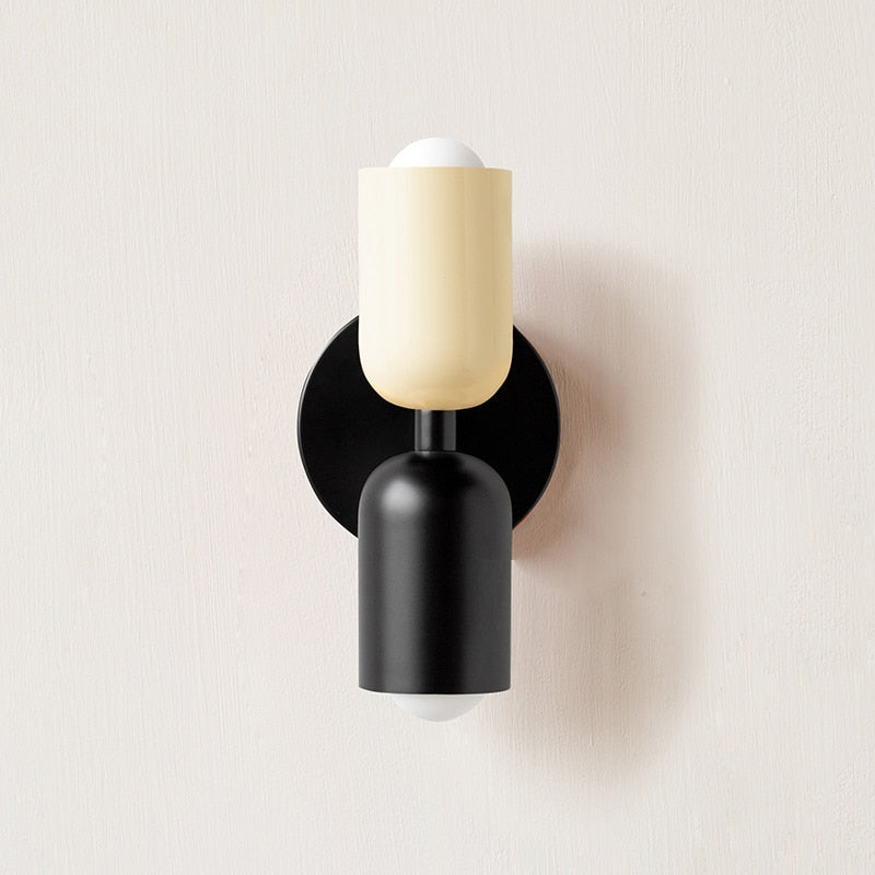Dual-bulb wall sconce in bedroom setting — bold pink matte finish | Casa Norex