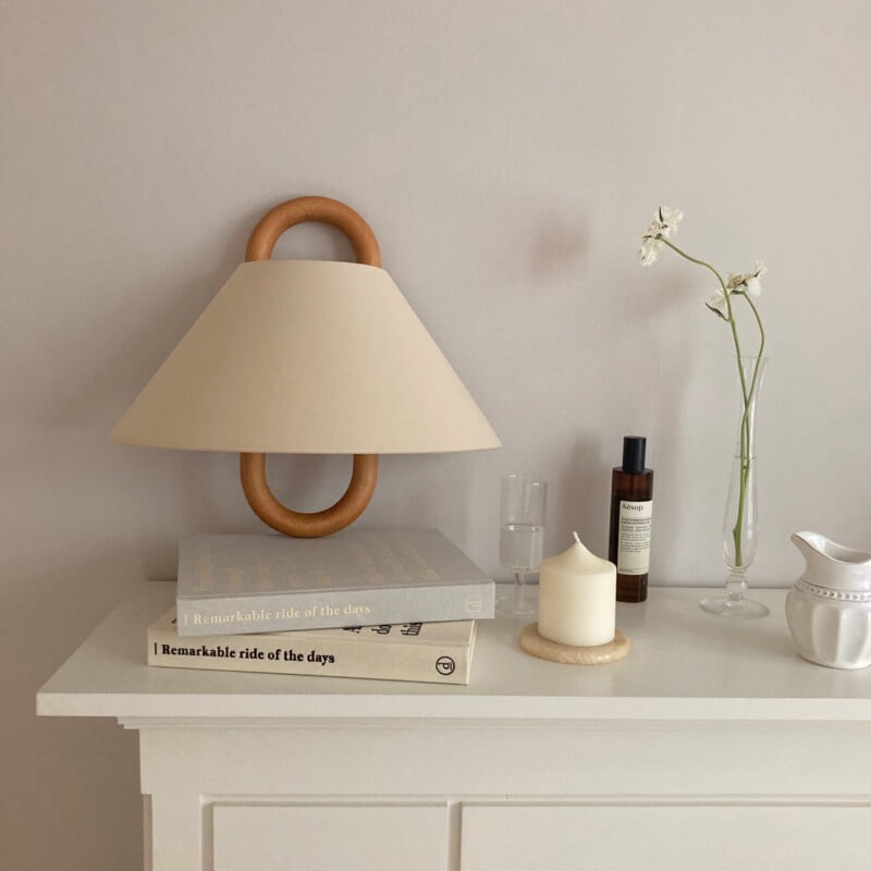 Wall sconce in bedroom setting — warm ambient pleated shade lighting | Casa Norex