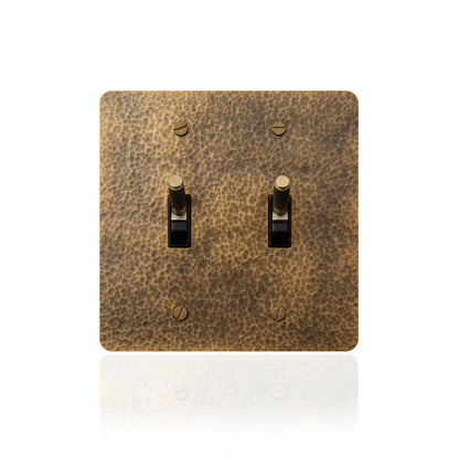 Close-up of 2-gang hammered brass toggle switch panel | Casa Norex