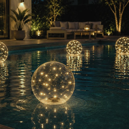 Lagoon floating solar pool light orbs glowing on a backyard pool at night