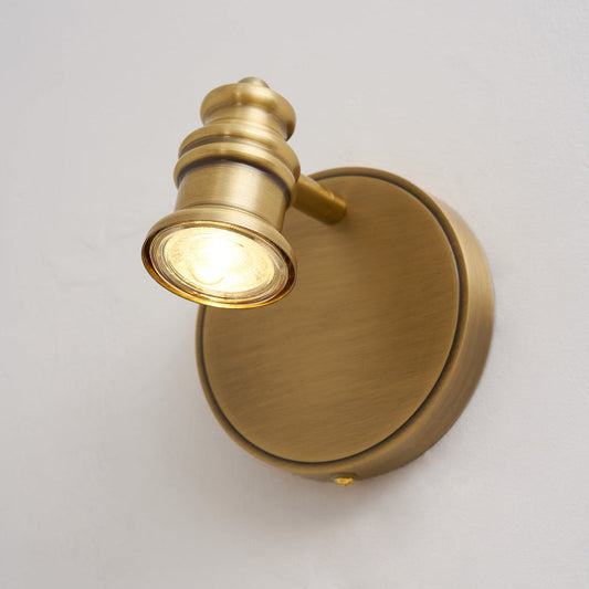 Brass wall sconce — single spotlight head on a round backplate | Casa Norex