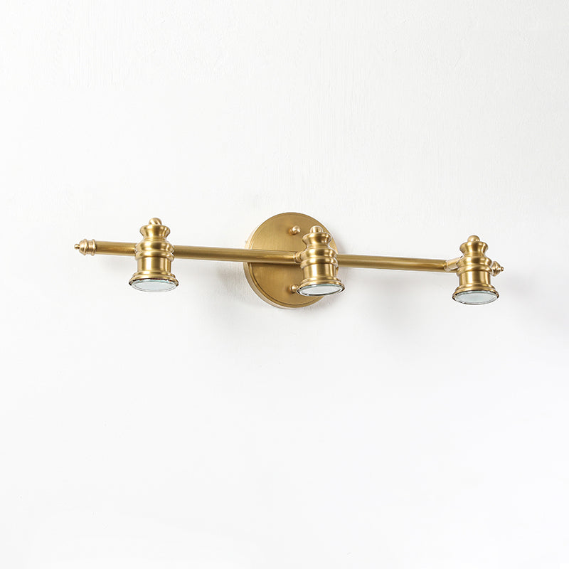 Close-up of the three-head brass spotlight bar on a wall sconce | Casa Norex