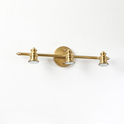 Close-up of the three-head brass spotlight bar on a wall sconce | Casa Norex
