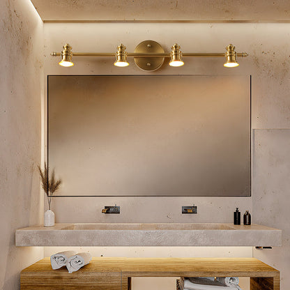 Four-head brass wall sconce lighting a framed bathroom mirror — Casa Norex