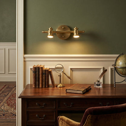 Brass spotlight bar lighting a wooden desk against a green panelled wall — Casa Norex