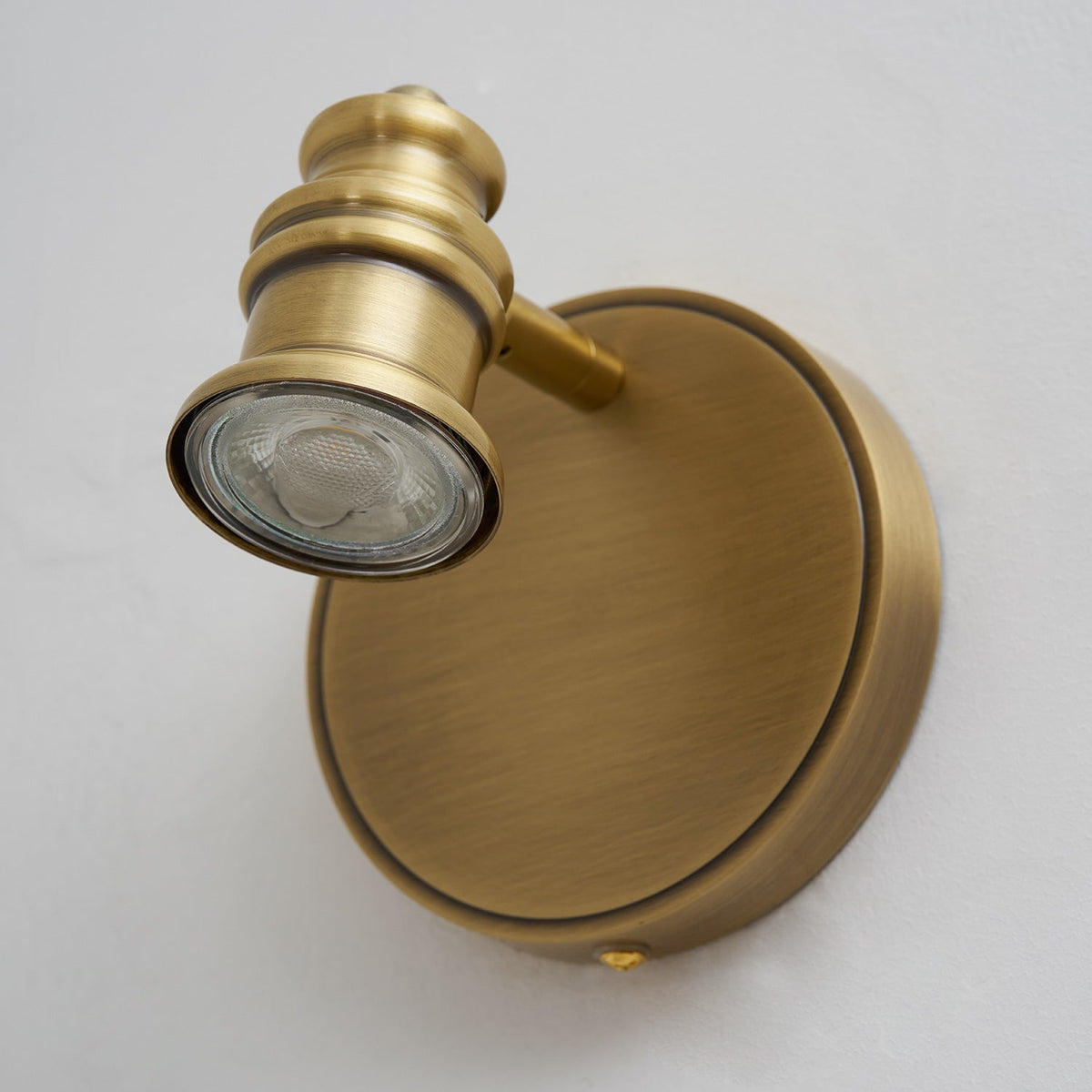 Close-up of a turned-brass spotlight head with a flush lens — Casa Norex