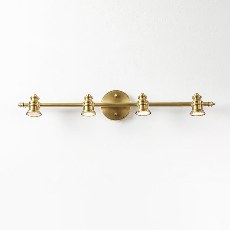 Three-head brass spotlight bar wall sconce on a white wall — Casa Norex