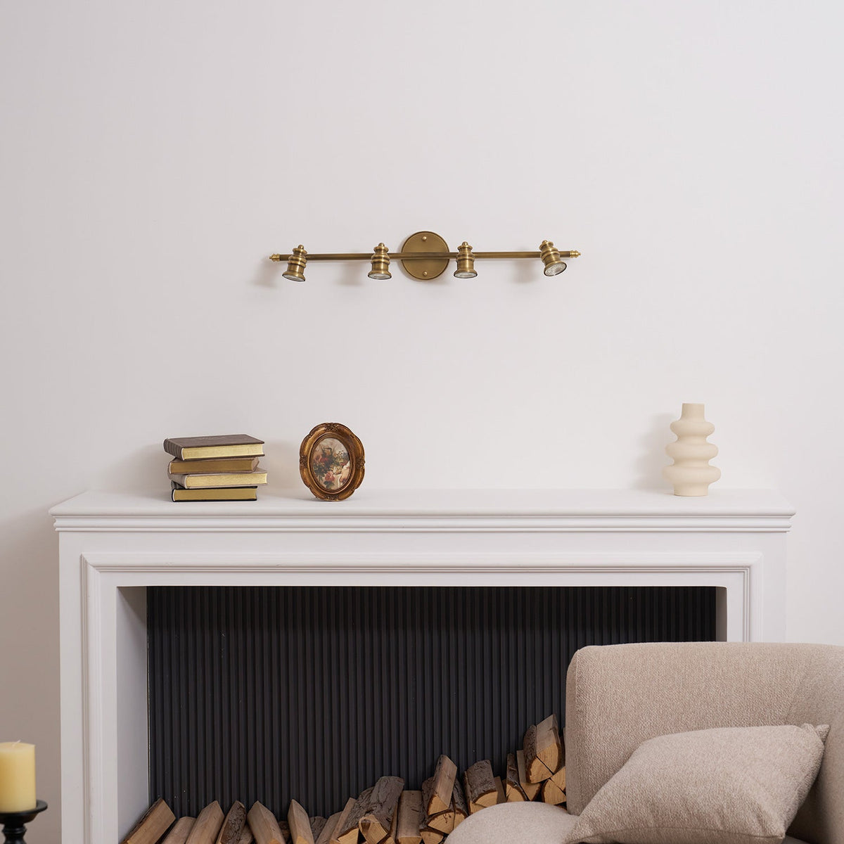 Brass spotlight bar above a white mantel and fireplace — Casa Norex