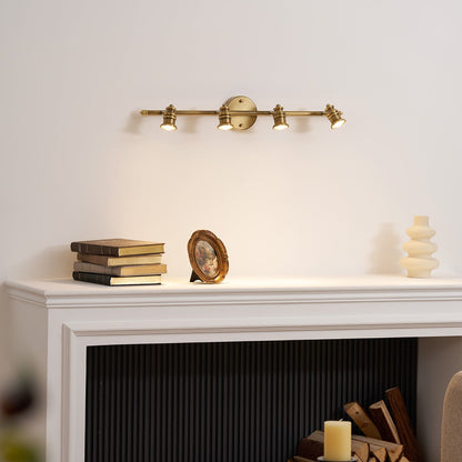 Long brass spotlight bar above a white fireplace mantel — Casa Norex