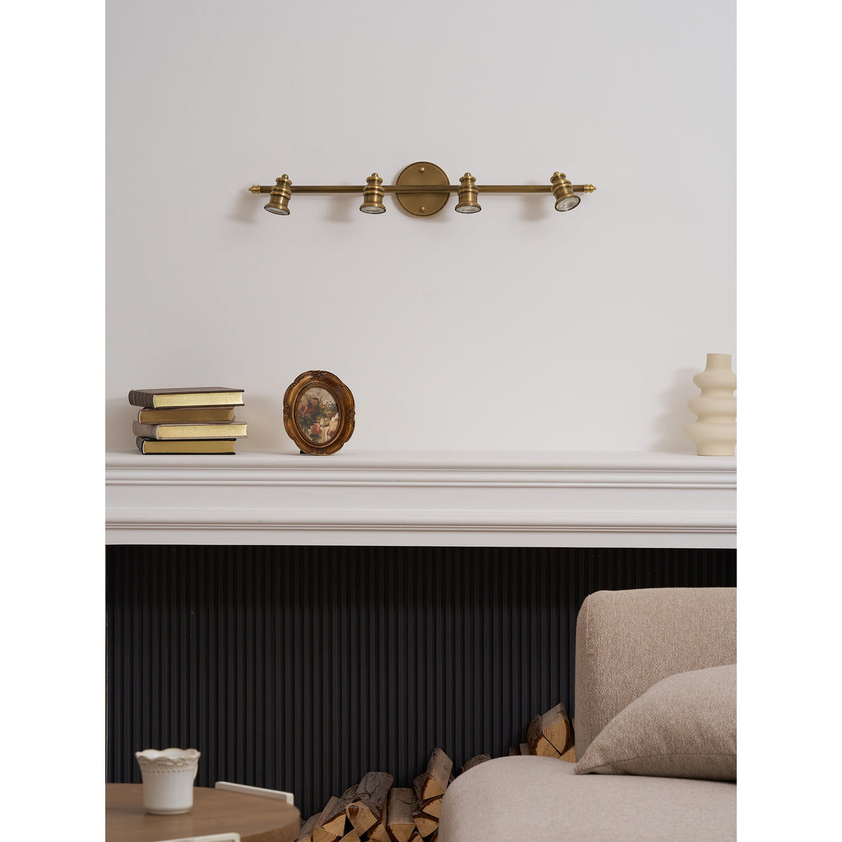 Brass spotlight bar above a mantel in a living room — Casa Norex