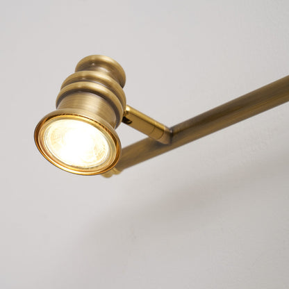 Close-up of a brass spotlight head angled on its bar — Casa Norex