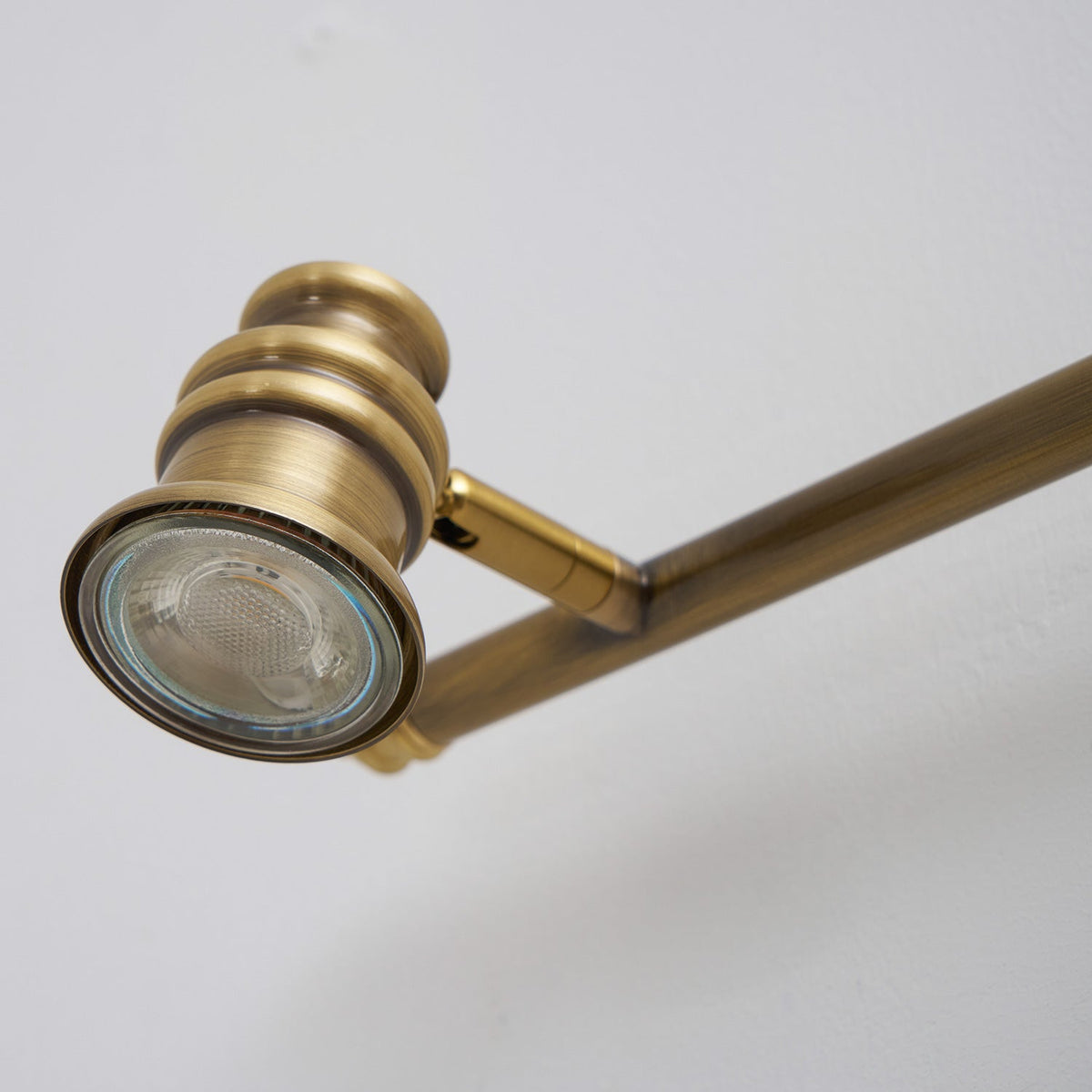 Close-up of a brass spotlight head with its lens facing the viewer — Casa Norex