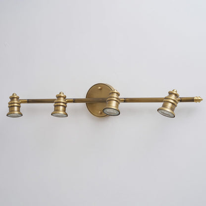 Macro view of a brass spotlight head at the end of the bar — Casa Norex