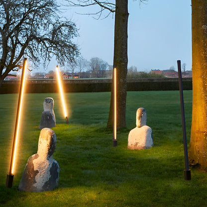 Linear floor lamp lit warm white on terrace — Casa Norex