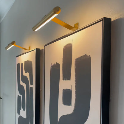 Gold picture light angled over large abstract art — Casa Norex