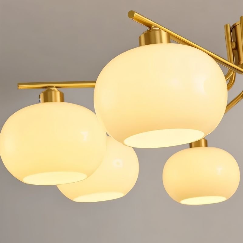 Close-up of frosted opal glass globes on chandelier metal frame | Casa Norex