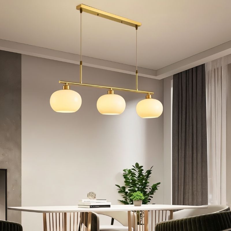 Chandelier in dining room setting — linear 3-light configuration, gold finish | Casa Norex