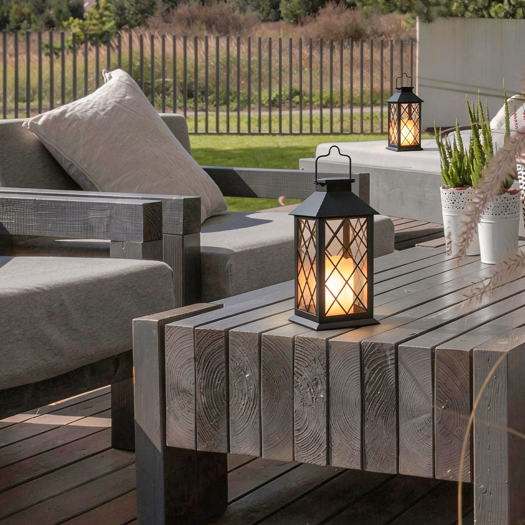 Wicklow black lantern on a rustic wood patio table in the evening — Casa Norex
