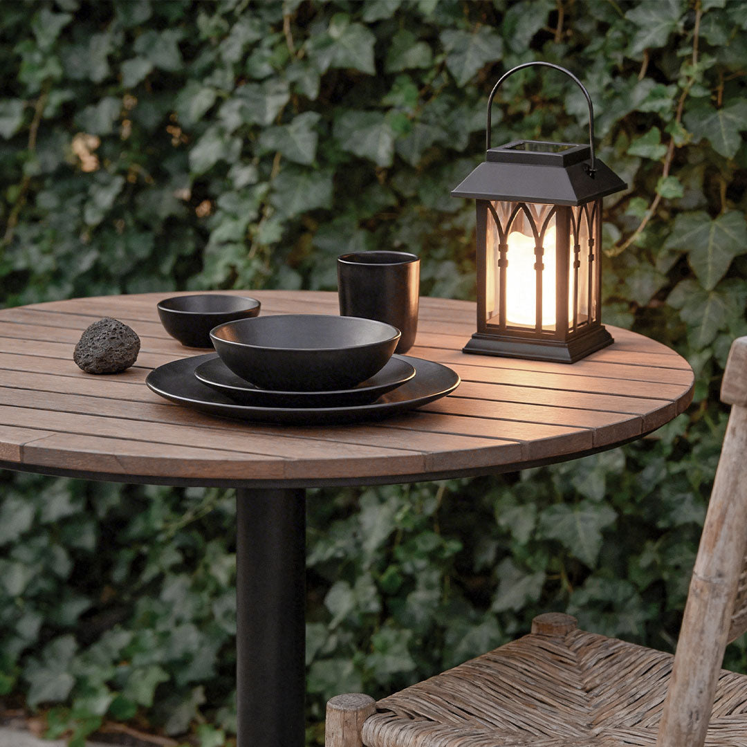 Wicklow lantern on a wooden dinner table with ivy decor — Casa Norex