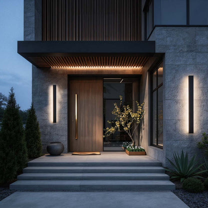 Long linear outdoor wall light at contemporary doorway with warm ambient glow — Casa Norex
