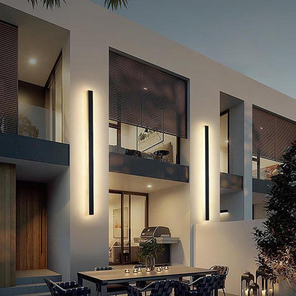 Long linear outdoor wall light — black metal body with iron shade in outdoor corridor | Casa Norex