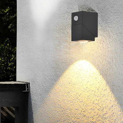 Black up down outdoor wall light on textured wall — architectural detail | Casa Norex
