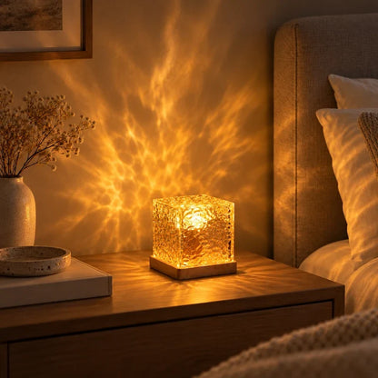Warm amber aurora light patterns on a wall beside a vase of dried flowers — Casa Norex