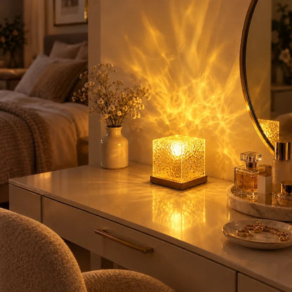 Amber textured acrylic cube lamp on a vanity beside a mirror and flowers — Casa Norex
