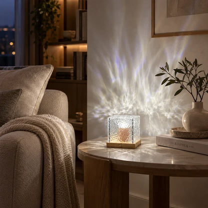 White cube night light on a round side table beside a sofa in a living room — Casa Norex
