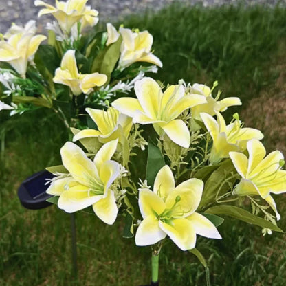 Yellow lily stake lights with a solar stake on a lawn in daylight — Casa Norex