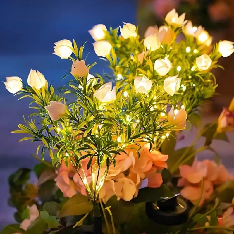 Cream and peach peony stake lights glowing at dusk — Casa Norex