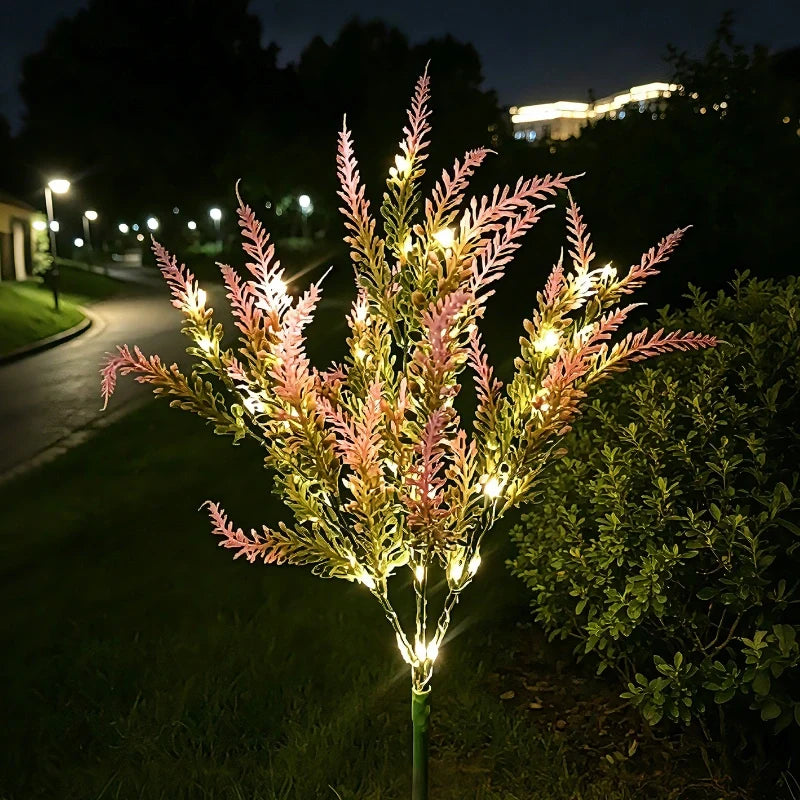 Pink lavender stake lights glowing in a garden at dusk — Casa Norex