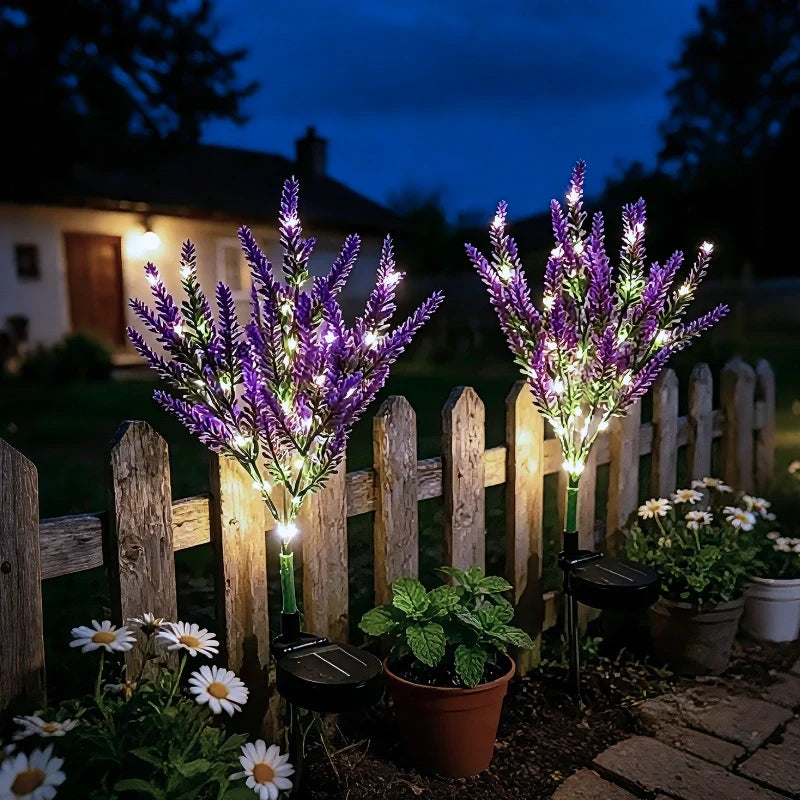 Purple lavender stake lights beside a picket fence at dusk — Casa Norex