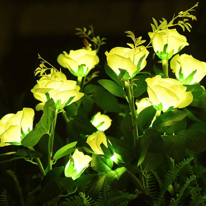Yellow lily stake lights glowing in a dark garden — Casa Norex