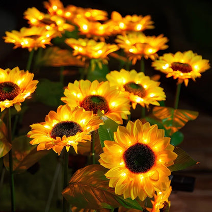 Sunflower stake lights glowing yellow at night — Casa Norex