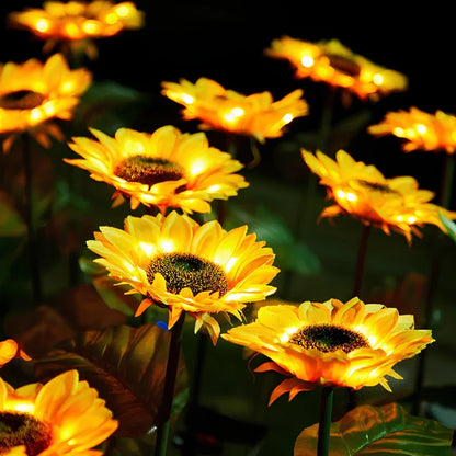 Row of sunflower stake lights lit warm yellow — Casa Norex