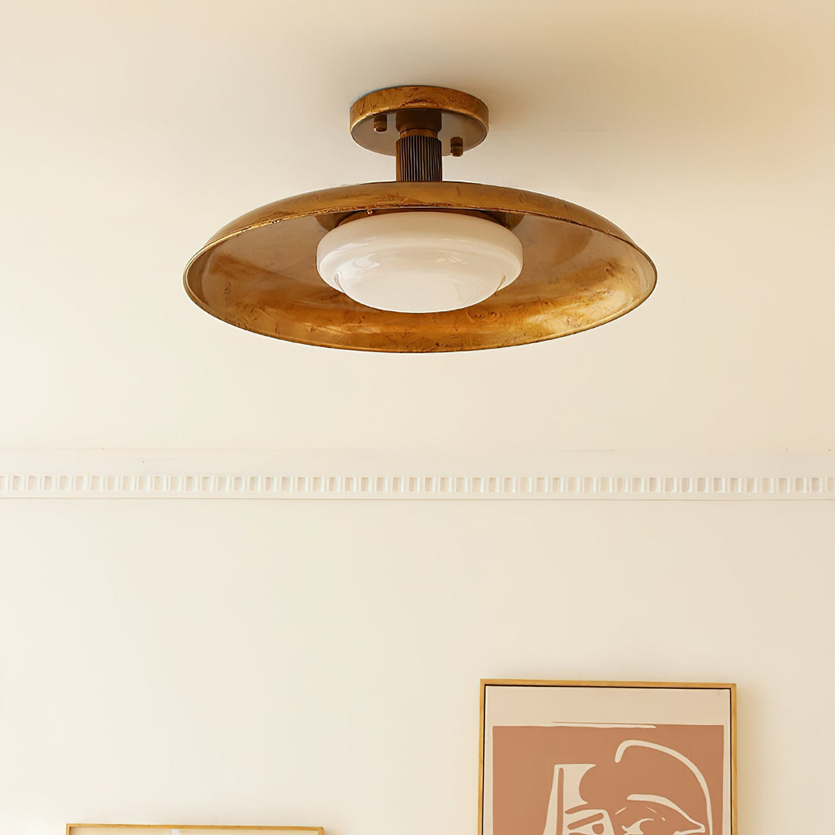 Flush mount ceiling light in gilded iron against a cream wall and ceiling | Casa Norex