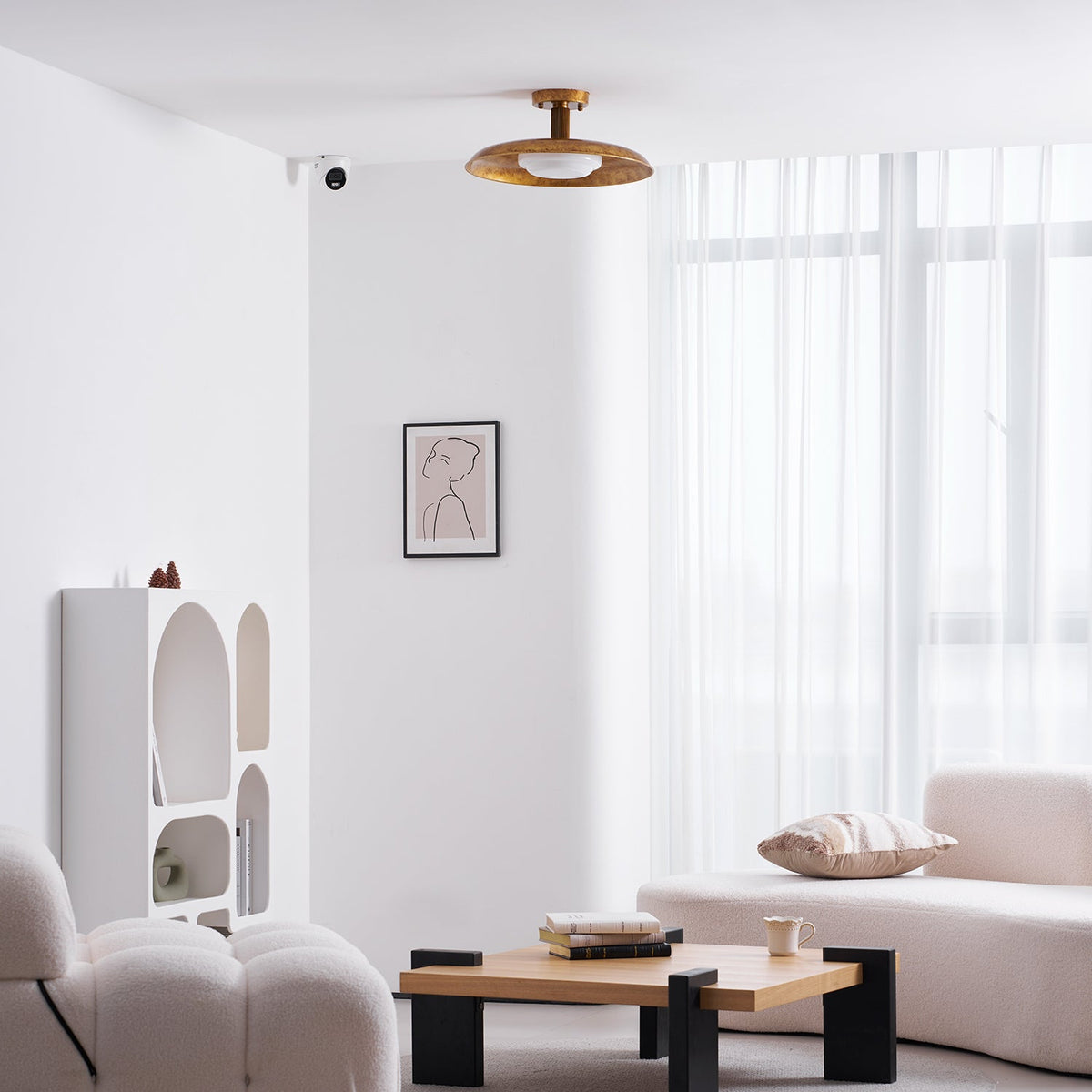 Gilded iron ceiling light in a bright living room with sheer curtains — Casa Norex