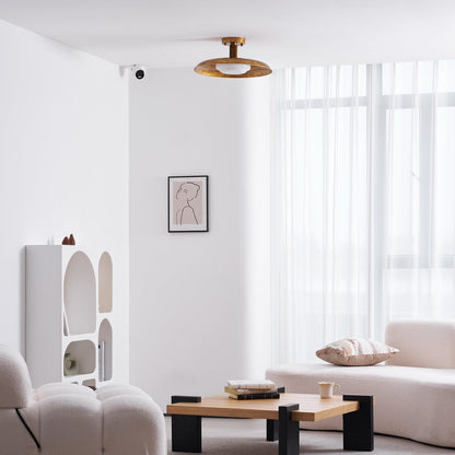 Gilded iron ceiling light in a bright living room with sheer curtains — Casa Norex