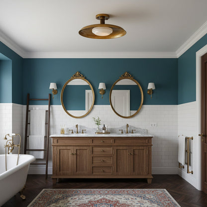 Gilded iron ceiling light above a double vanity with round mirrors — Casa Norex