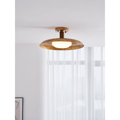 Gilded iron ceiling light lit above a wall with sheer curtains — Casa Norex