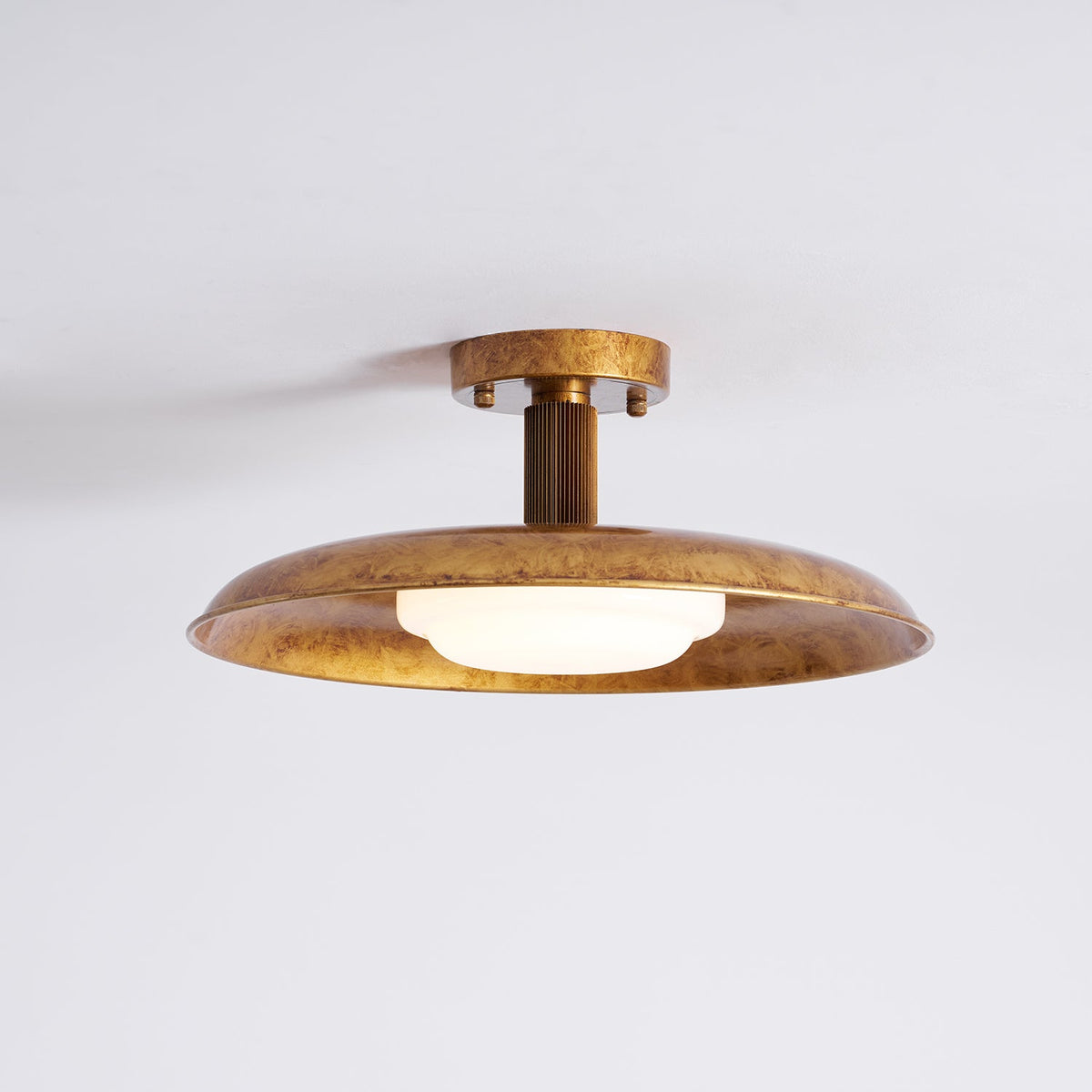 Gilded iron flush mount with a lit frosted glass diffuser — Casa Norex