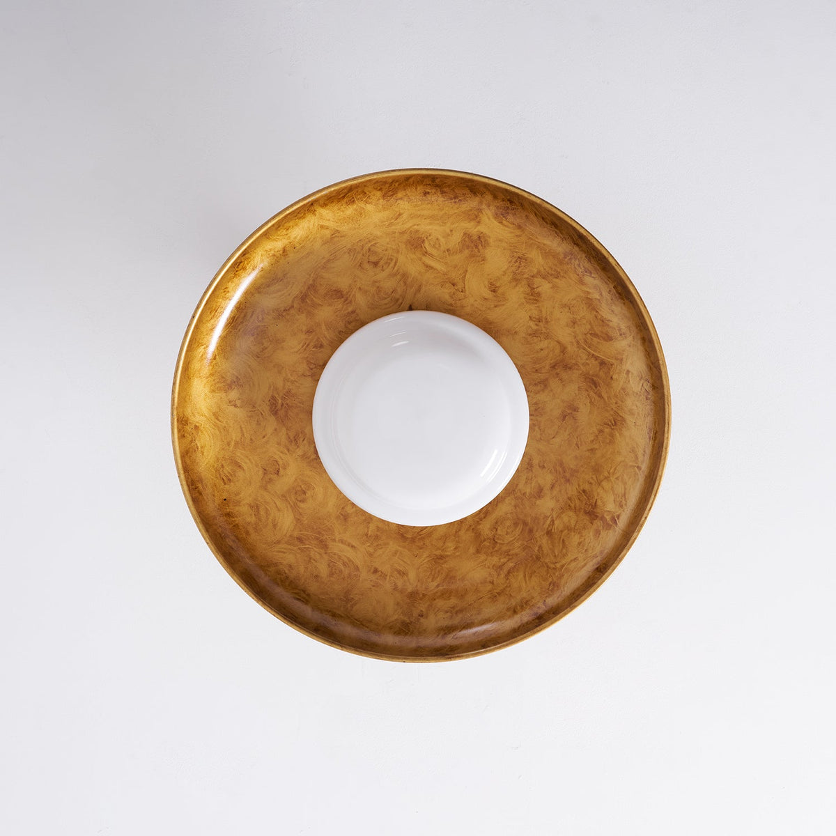 Gilded iron ceiling light seen from directly below, unlit — Casa Norex